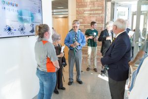 Picutre of alumni and friends inside chemistry research building at grand opening celebration