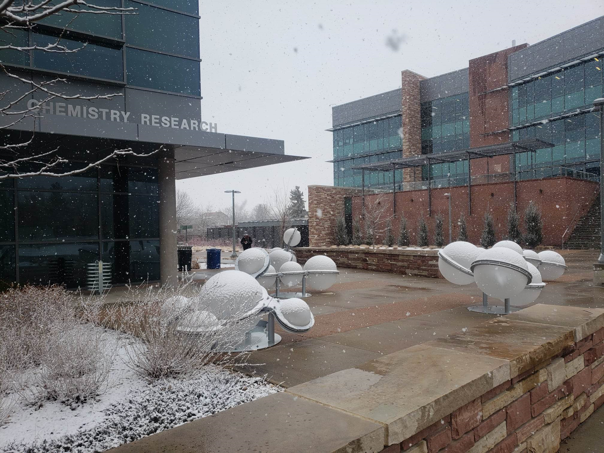Photo of outside of Chemistry Research building in winter with elements sculptures