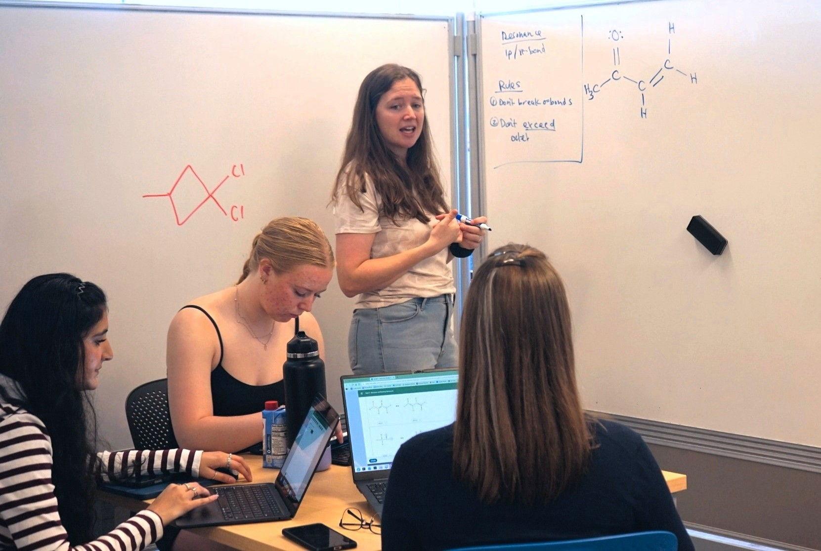 dsc04817.2 Professor Melissa Denler helping students with chemistry concepts.