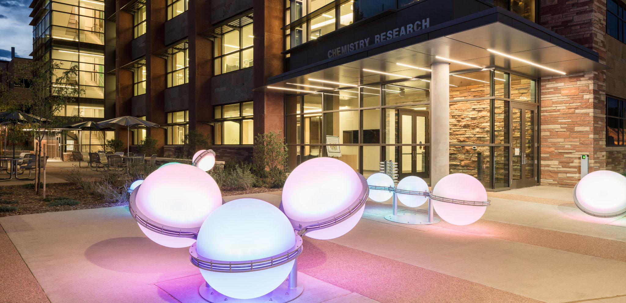 Photo of elements sculptures outside Chemistry Research at night