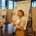 Student presents research at showcase.