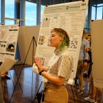 Student presents research at showcase.